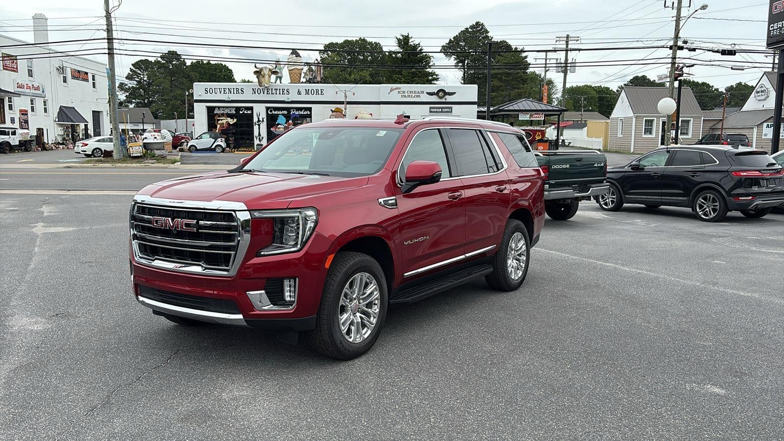 2024 GMC Yukon SLT in Volcanic Red Tintcoat — front three-quarter view